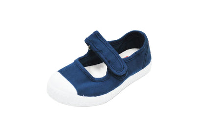 Navy blue canvas Mary Jane shoe with a white rubber toe cap, white sole, and a single velcro strap.