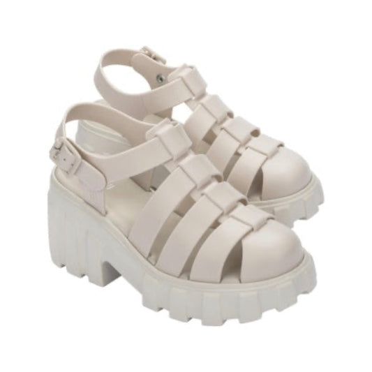 Pair of light beige Mini Melissa Megan platform sandals with a caged upper, ankle strap, and chunky lug sole.