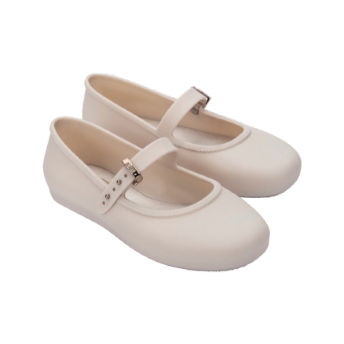 Pair of light beige Mini Melissa Soft Ballerina shoes with a single strap and silver buckle on a white background.