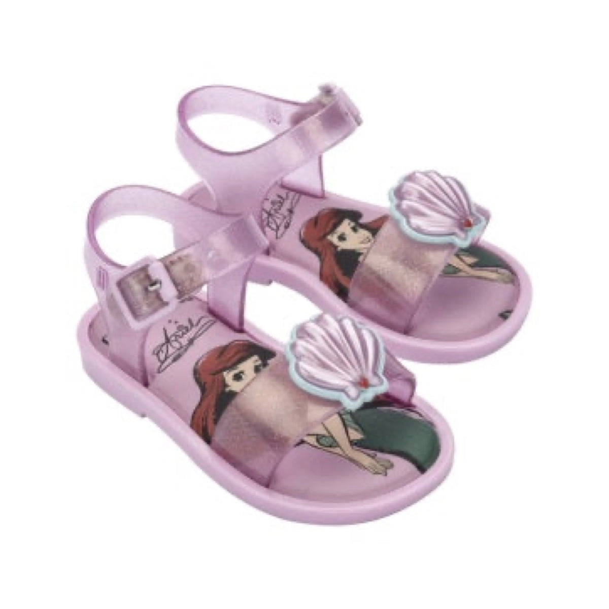 Pair of shiny pink children's sandals featuring Disney's Ariel character print, 3D seashell embellishments, and an adjustable ankle strap.
