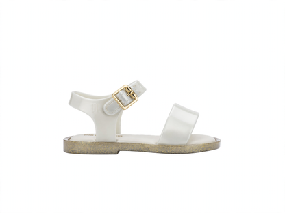 Mini Melissa Mar baby sandal in translucent white with a glittery gold sole and a gold buckle on the ankle strap.