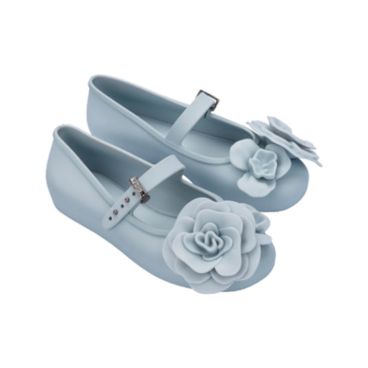 Pair of light blue children's ballerina flats with floral petal embellishments on the toe and an adjustable strap.