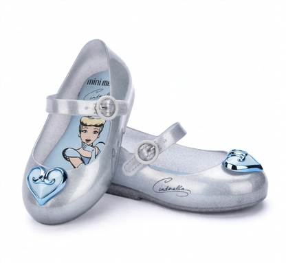 Silver glitter Mini Melissa children's Mary Jane flats featuring light blue Cinderella insoles and distinct blue toe embellishments.