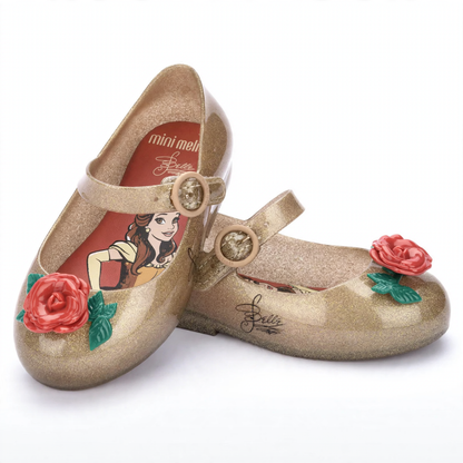 Sparkly gold Mary Jane style shoes with red rose accents, featuring Disney's Belle on the insole and a signature on the side.