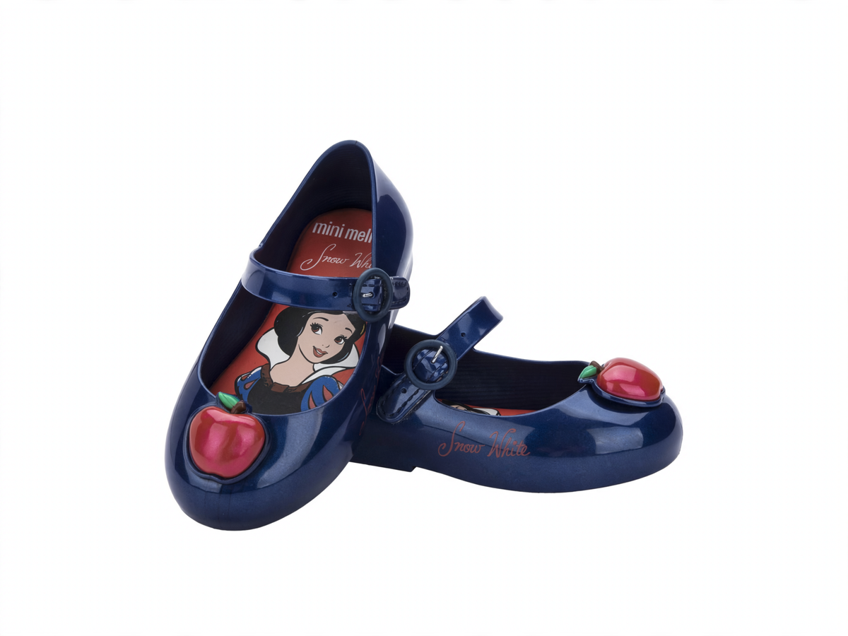 Pair of dark blue Mini Melissa Mary Jane flats for babies, featuring a Snow White insole and a red apple on the toe.