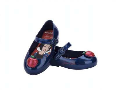 Pair of dark blue Mini Melissa Mary Jane flats for babies, featuring a Snow White insole and a red apple on the toe.