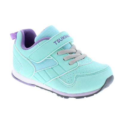 Mint green and purple children's sneaker with grey laces, a Velcro strap featuring the TSUKIHOSHI logo, and a purple pull tab.