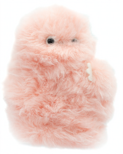 A fuzzy, fluffy pink robotic plush toy with small black eyes and a small white tooth, photographed against a soft light blue background.