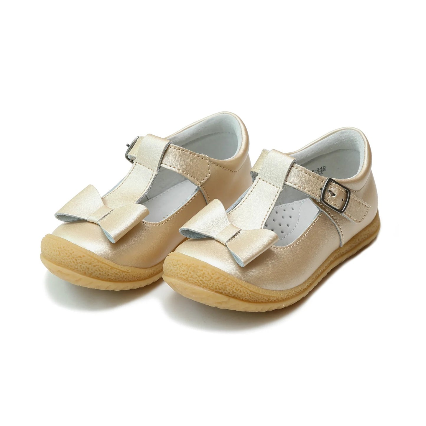 Pair of L'Amour Emma children's gold metallic T-strap shoes with a decorative bow on the toe and a textured rubber sole.