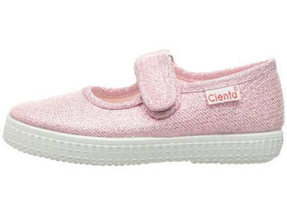 Sparkly pink Cienta Mary Jane style shoe with a hook-and-loop strap and white rubber sole, viewed from the side.