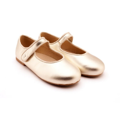 Pair of metallic gold children's Mary Jane flats with a single hook-and-loop strap and rounded toes.