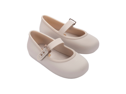 Pair of light beige Mini Melissa Soft Ballerina baby shoes with a single strap and buckle closure.