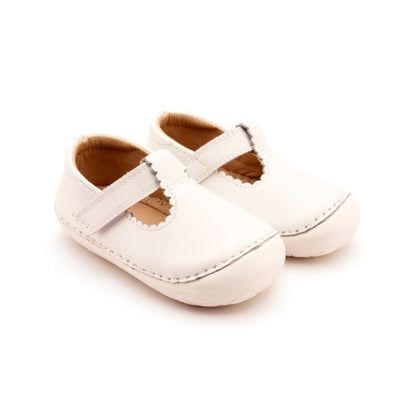 Pair of white leather Mary Jane style baby shoes with scalloped edges and velcro straps, on a white background.