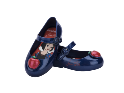 Pair of dark blue Mini Melissa Mary Jane flats for babies, featuring a Snow White insole and a red apple on the toe.