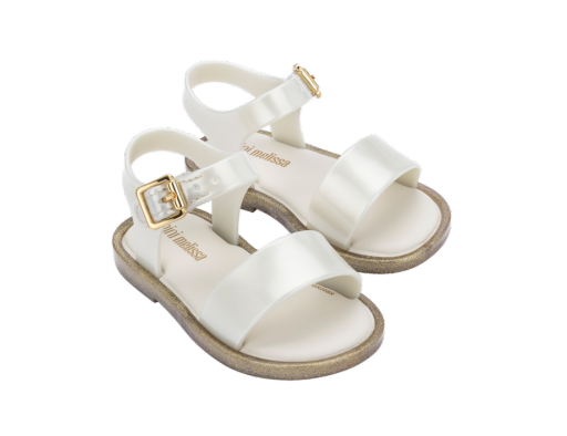 Pair of shiny white Mini Melissa baby sandals with gold glitter soles and gold buckles.