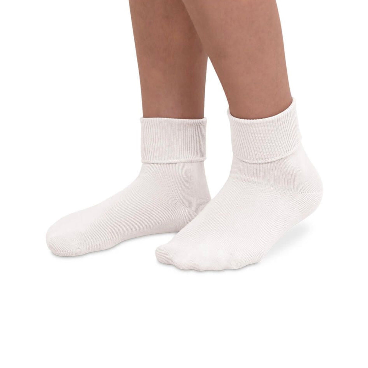 Child's legs wearing white smooth toe turn cuff socks, showing the ribbed cuff folded down.