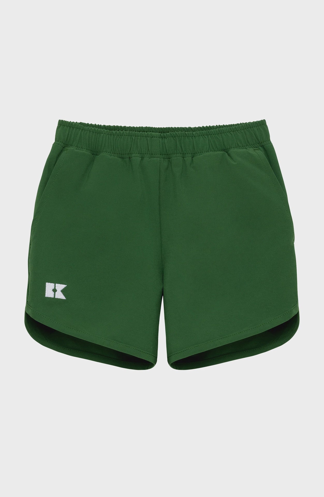 Dark green children's athletic shorts with an elastic waistband, a white 'RK' logo on the left leg, and rounded hems.