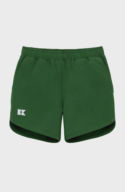 Dark green children's athletic shorts with an elastic waistband, a white 'RK' logo on the left leg, and rounded hems.