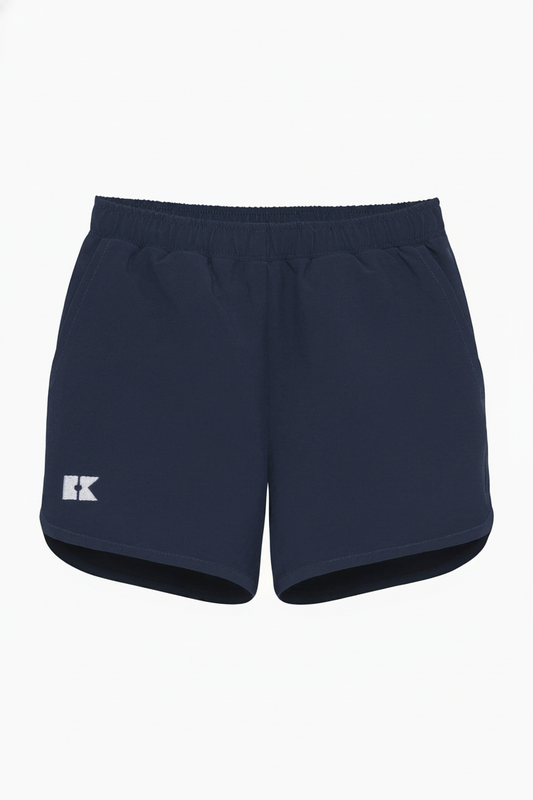 Navy blue athletic shorts with an elastic waistband, side pockets, a white logo on the left leg, and a curved hem.
