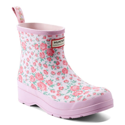 Pink and white Hunter x LoveShackFancy short rain boot with a delicate pink rose floral pattern, light pink sole, and a red brand label.