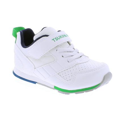 White Tsukihoshi children's athletic shoe with green accents, blue sole detail, navy lining, a Velcro strap, and laces.