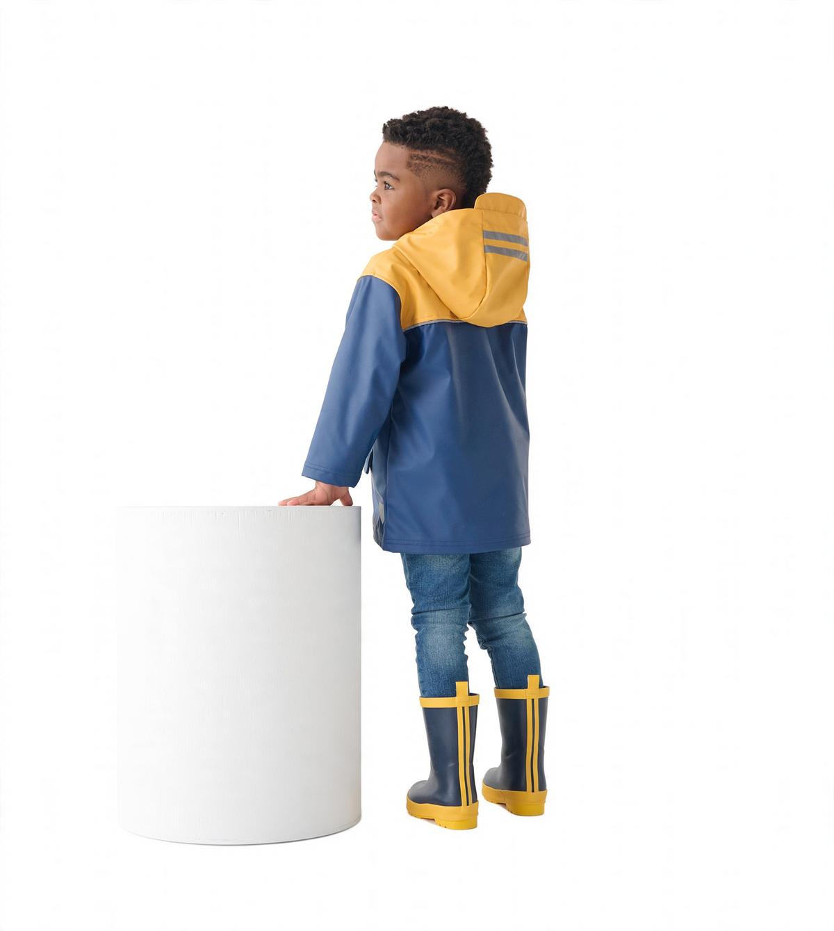 Yellow and navy zip-up rain jacket with a hood, worn by a child, paired with blue jeans and yellow rain boots.